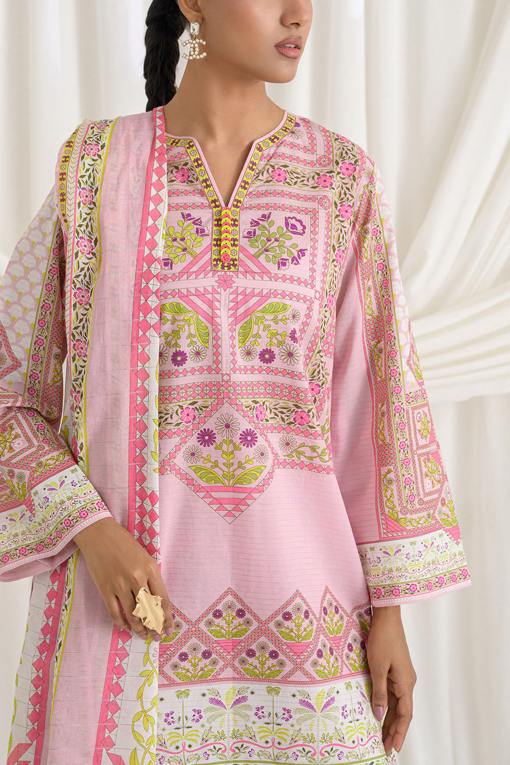 Pink embroidered traditional outfit with a white background