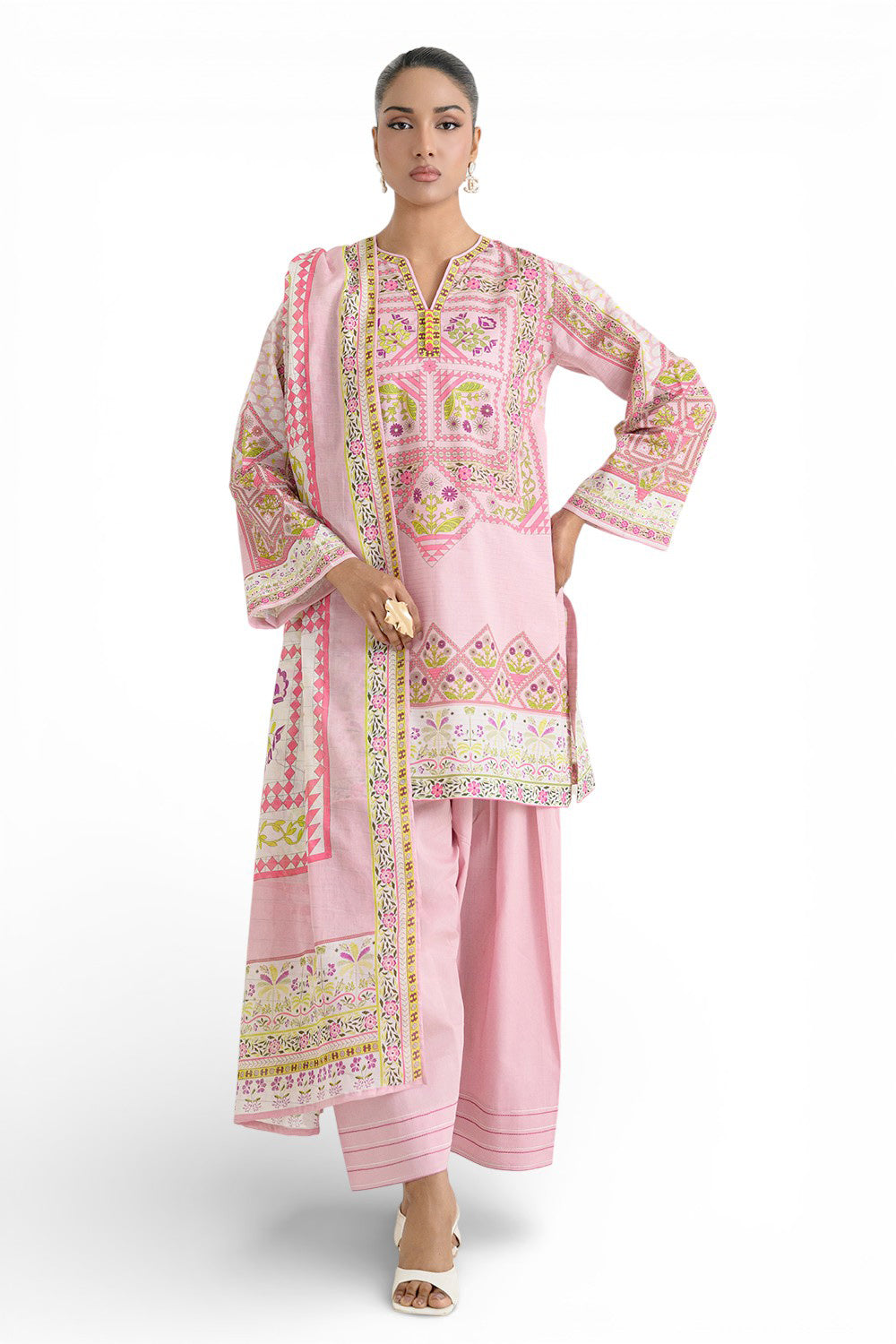 Woman wearing a pink embroidered traditional outfit on a white background