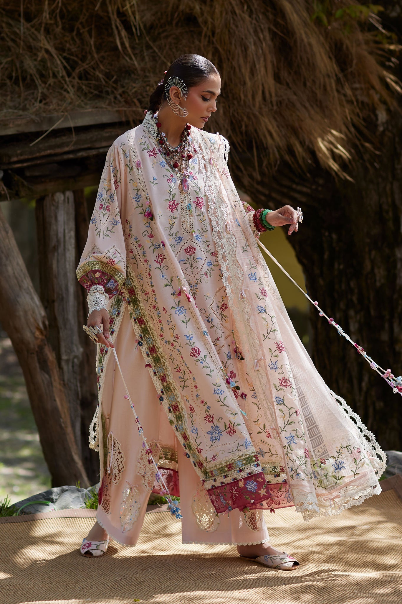 Woman in a floral dress walking a dog in a natural setting