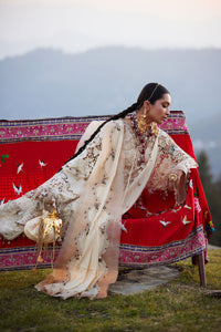 Woman in traditional attire with a scenic background