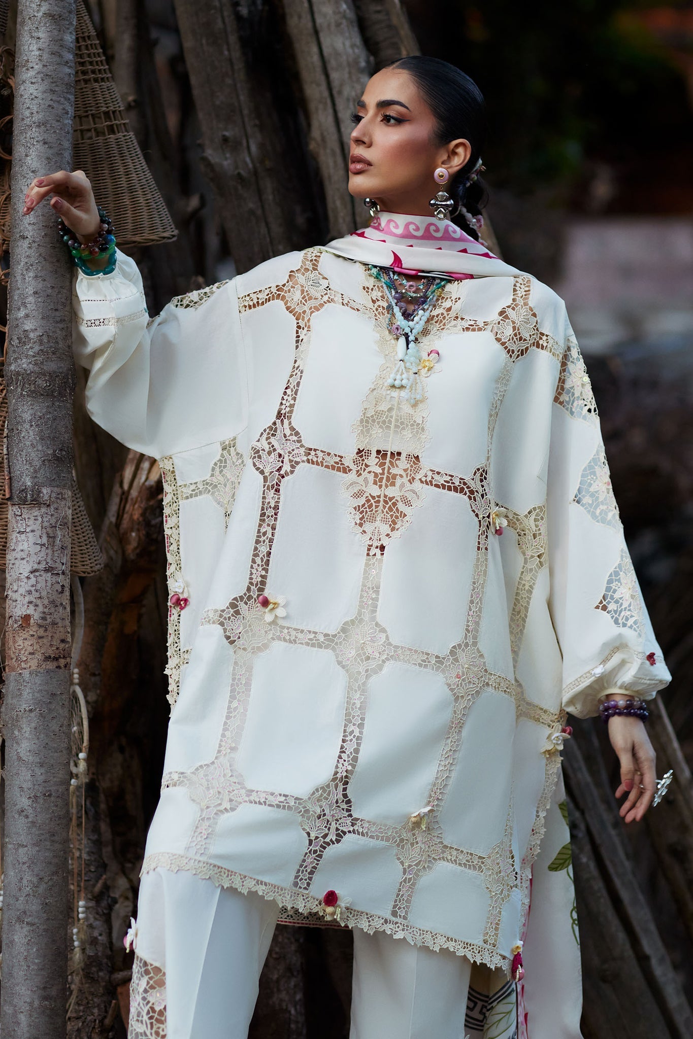 Woman wearing a white embroidered traditional outfit with a blurred background