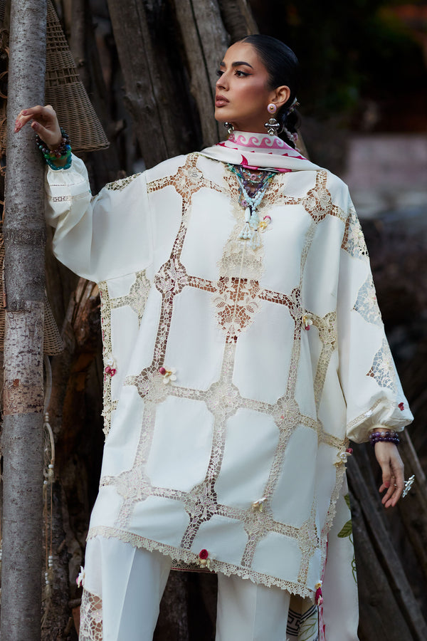 Woman wearing a white embroidered traditional outfit with a blurred background