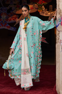 Woman in a traditional outfit with floral patterns on a red carpet