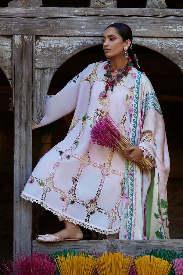 Woman in a traditional outfit holding incense sticks in front of a wooden archway.