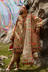 Woman in traditional embroidered outfit standing against a rocky background with colorful ribbons.