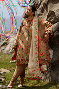 Woman in traditional embroidered outfit standing against a rocky background with colorful ribbons.