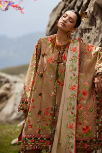 Woman in traditional embroidered outfit standing against a rocky landscape