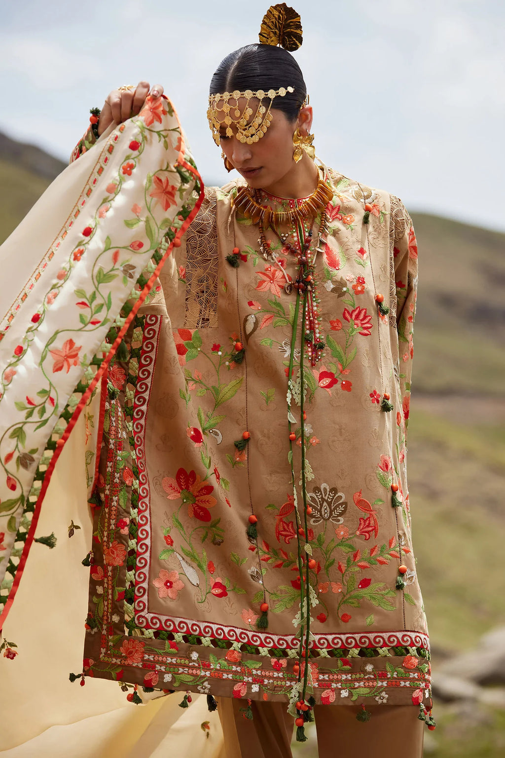 Woman in traditional embroidered outfit with scenic background