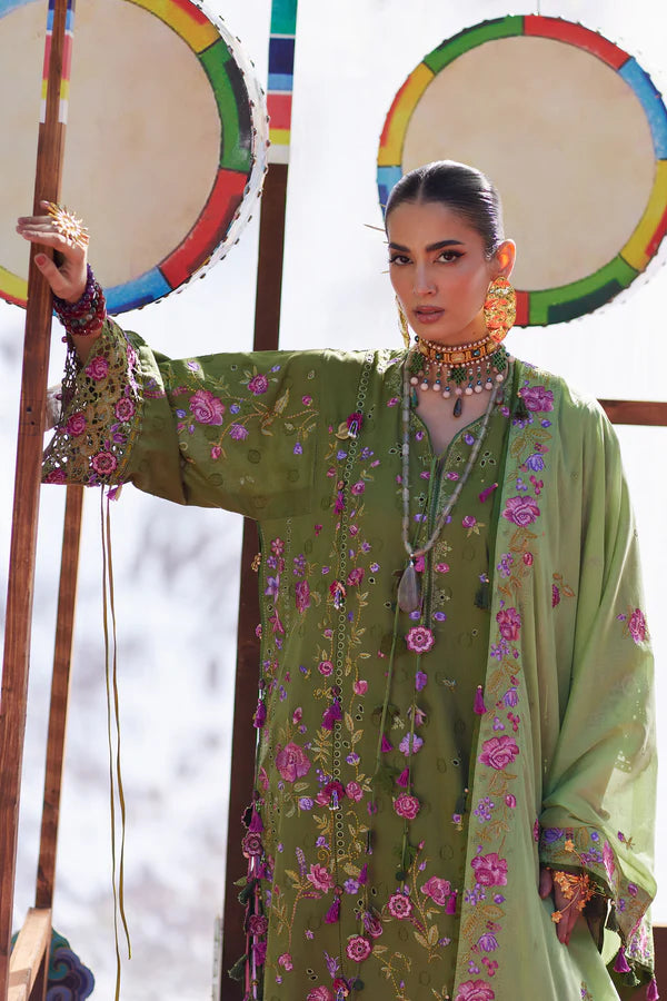 Woman in a green floral dress holding colorful drums against a blurred background
