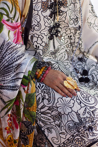 Person wearing a colorful outfit with floral patterns and accessories.