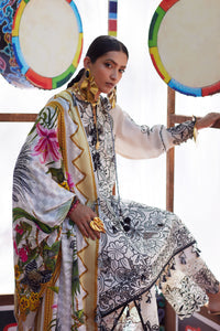 Woman in a patterned outfit with colorful drums in the background