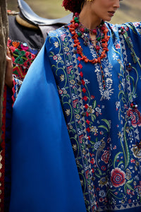 Traditional attire with a blue shawl and floral patterns, featuring an orange necklace.