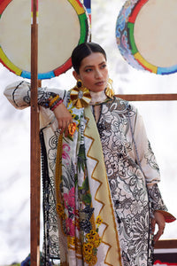 Woman wearing a patterned outfit with colorful scarves in a snowy landscape