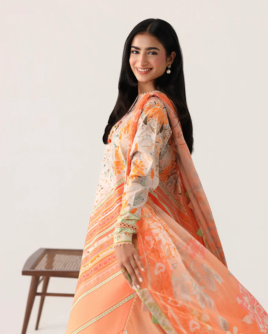 Woman wearing an orange saree with a white background
