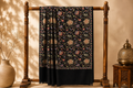 Floral patterned fabric draped over a wooden stand with a warm background