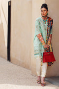 Woman in traditional outfit with a red handbag against a beige wall.
