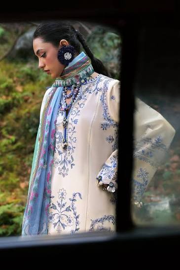 Person wearing a traditional outfit with floral patterns in an outdoor setting