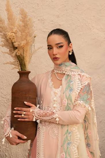 Woman holding a vase against a neutral background