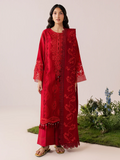 A woman modeling a long red embroidered kurta with matching pants in a studio setting with a light beige background and decorative plants at the bottom right.