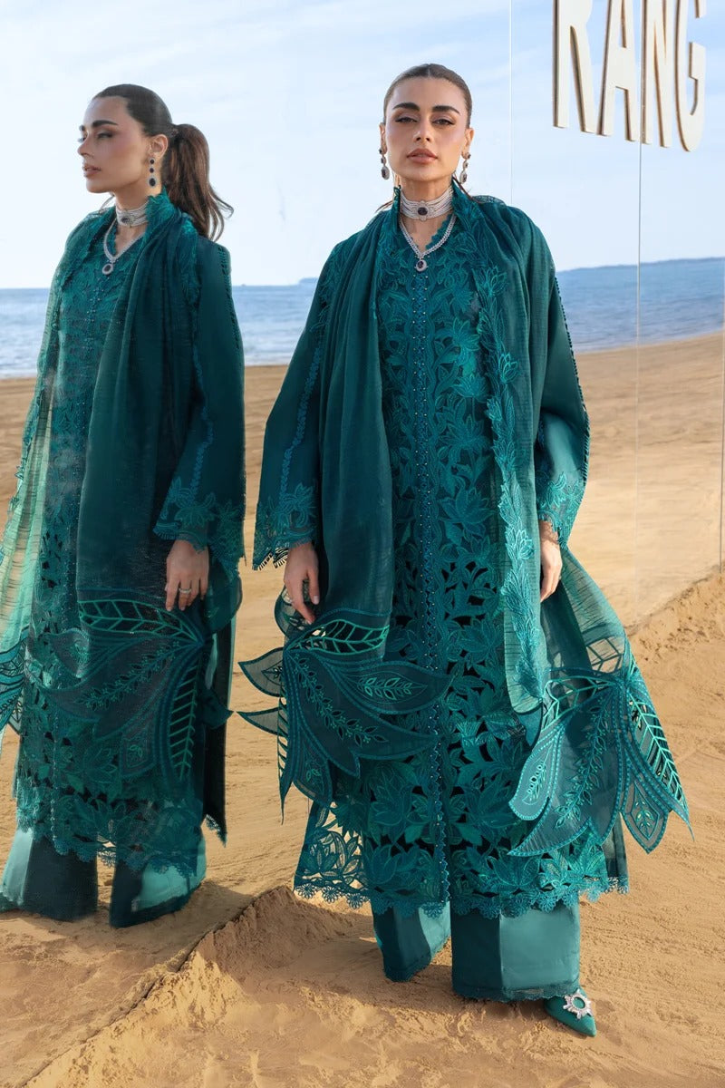 Woman in teal lace outfit standing on a beach with ocean view