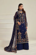 A woman models a navy blue traditional ethnic outfit with intricate floral embroidery in gold, pink, and white, featuring a long kurta, wide pants, and a matching sheer dupatta.