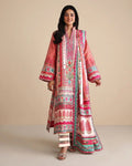 A woman modeling a long pink embroidered kurta with wide sleeves, paired with striped pants, against a solid beige studio background.