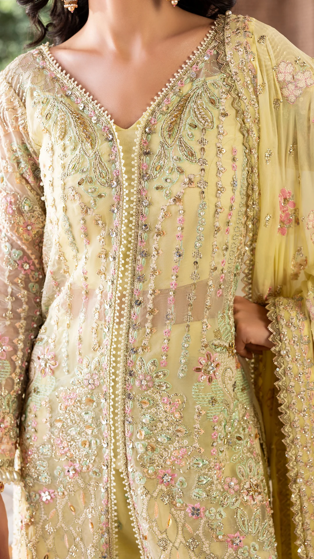 Light green embroidered traditional outfit with floral patterns