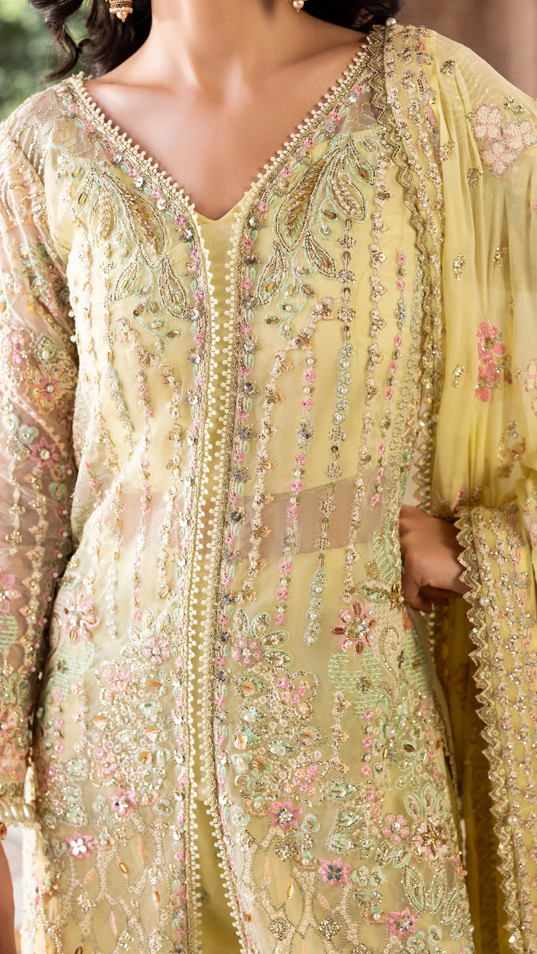 Light green embroidered traditional outfit with floral patterns