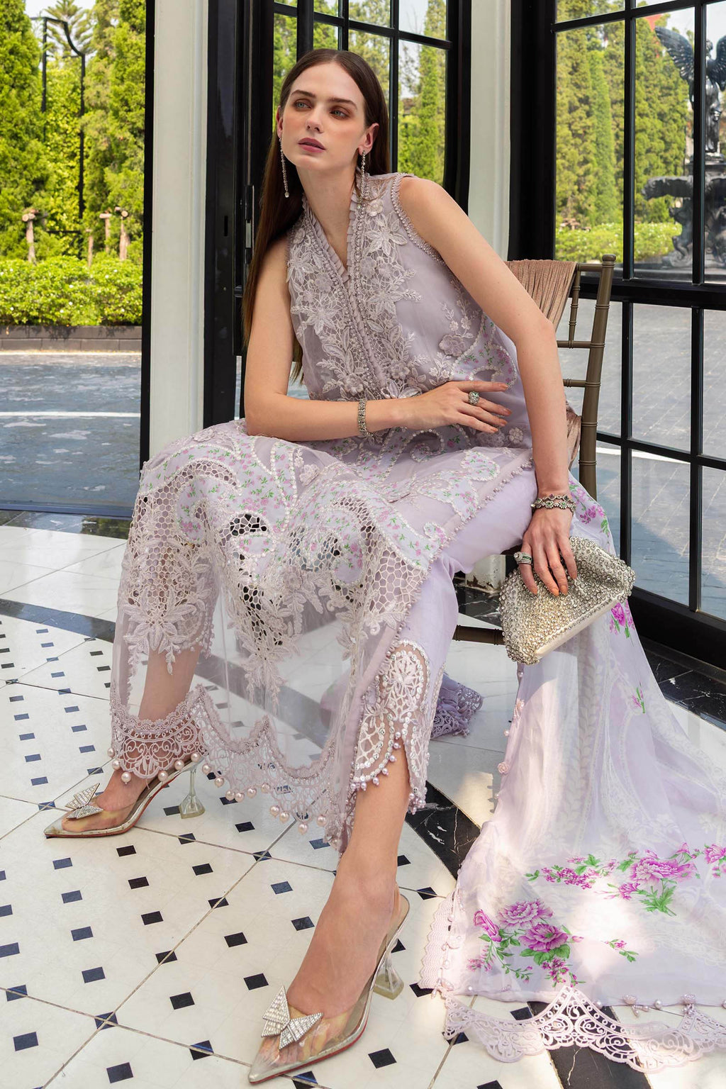 Woman in a floral dress sitting on a chair with a scenic background