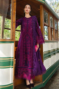 Woman in a purple embroidered dress standing on a vintage tram.