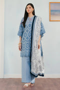 Woman wearing a blue and white traditional outfit with a matching dupatta in a room.