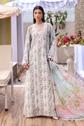Woman in a floral dress holding a matching dupatta in an outdoor setting with flowers and furniture.