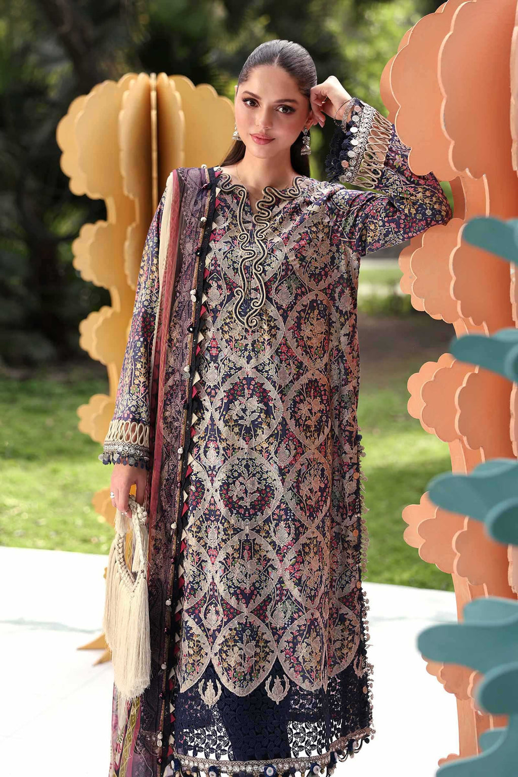 Woman wearing a patterned dress with a decorative background