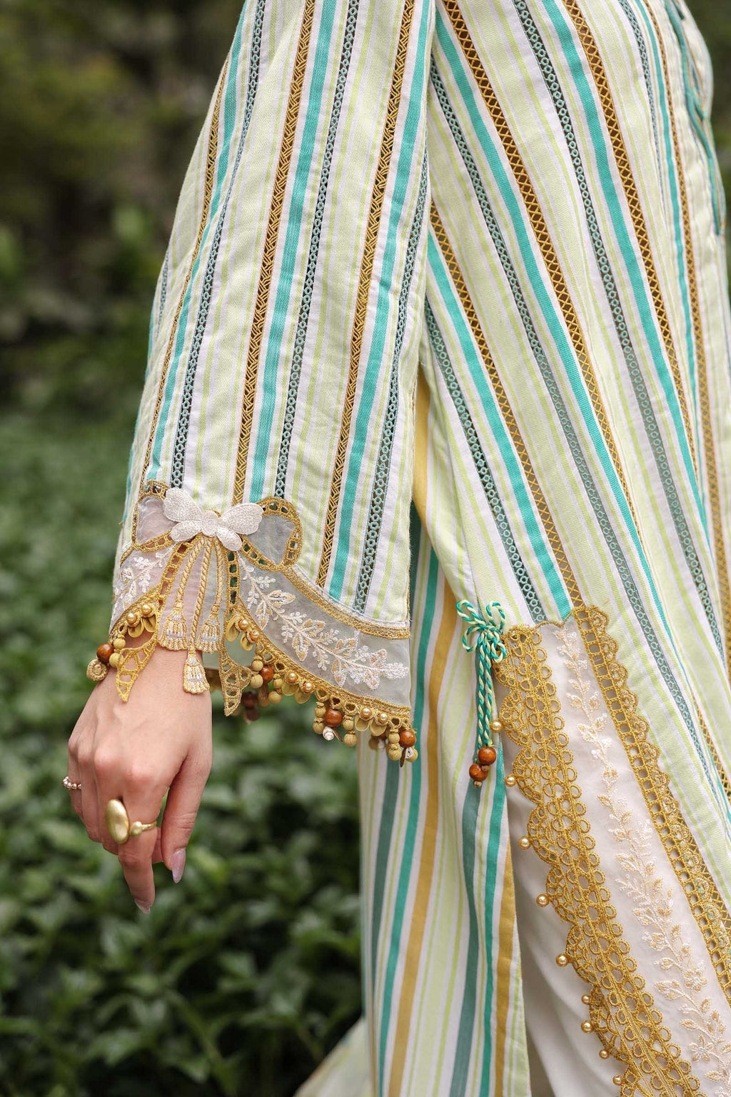 Close-up of a person wearing a traditional outfit with intricate patterns and embroidery.