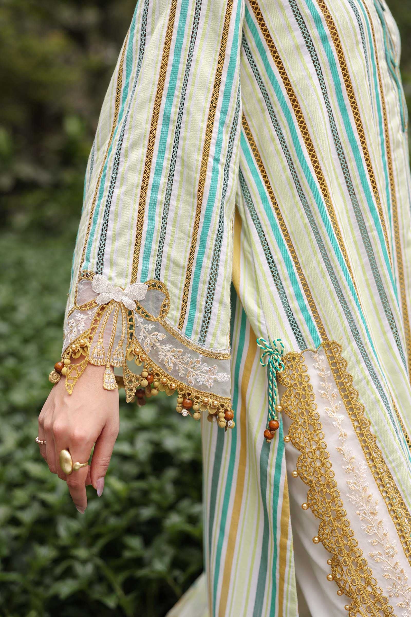 Close-up of a person wearing a traditional outfit with intricate patterns and embroidery.