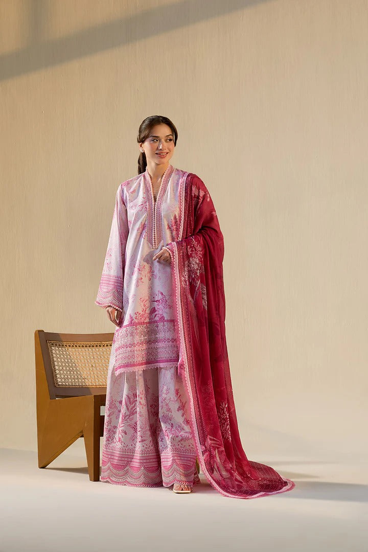 Woman wearing a traditional outfit with a pink and red patterned shawl against a neutral background