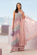 Woman in a patterned dress with a sheer pink overlay against a cityscape background