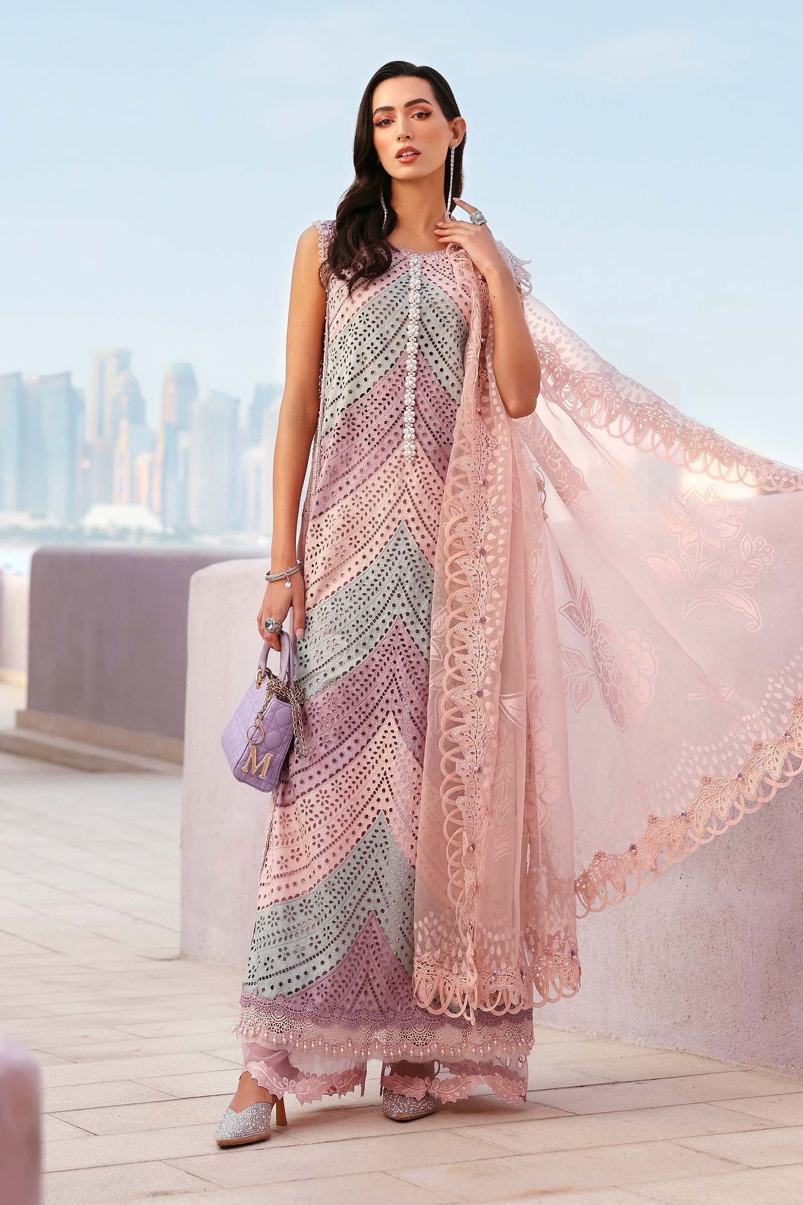 Woman in a patterned dress with a sheer pink overlay against a cityscape background