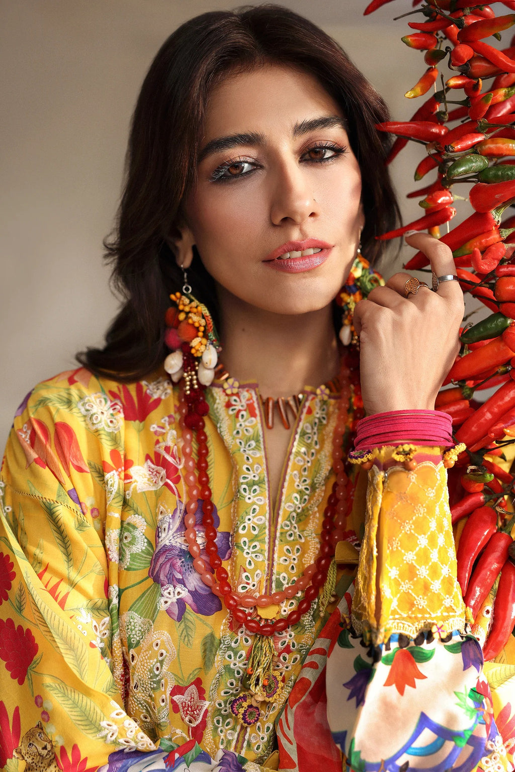 Woman in a colorful traditional outfit with a vibrant background