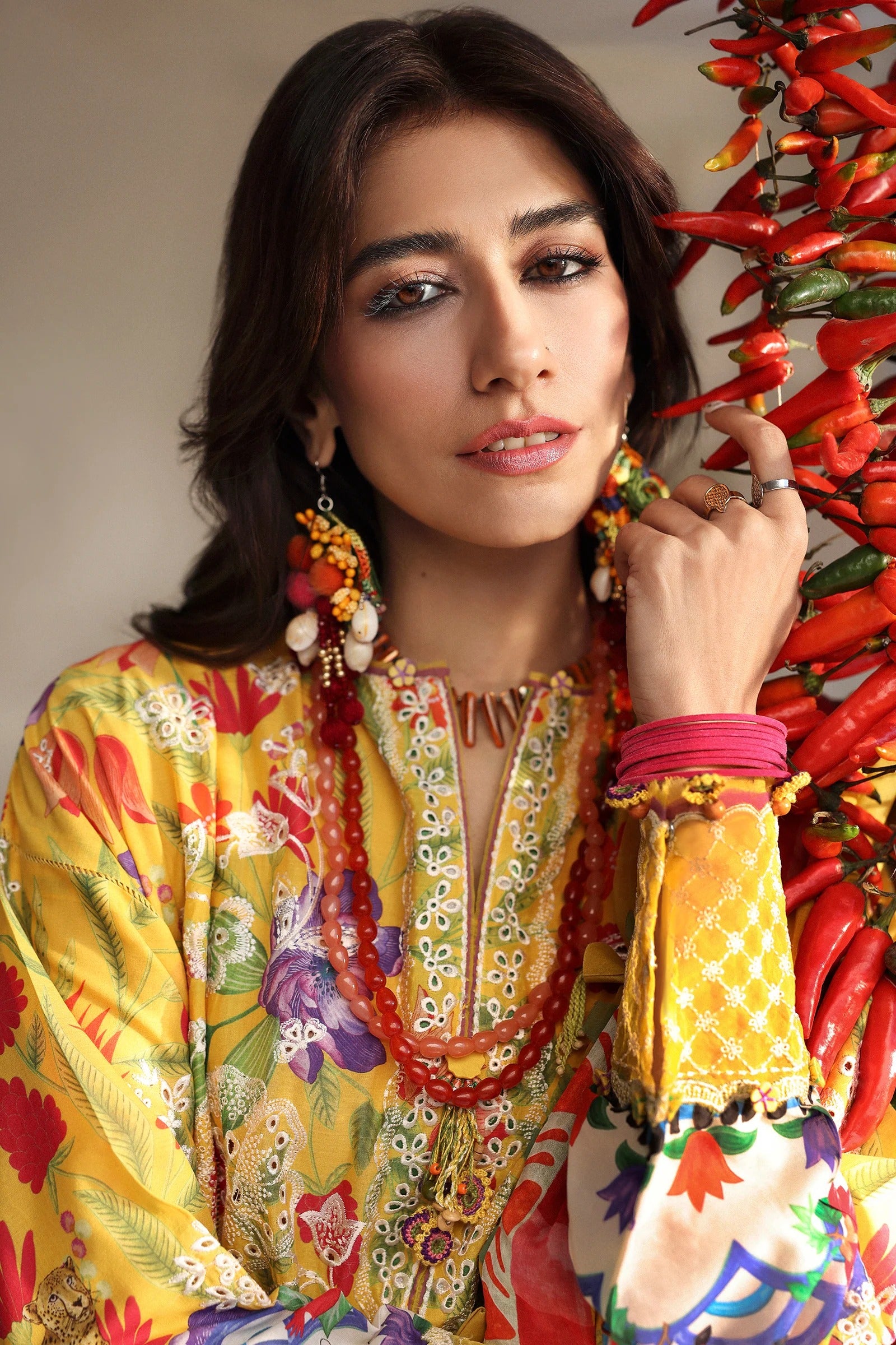 Woman in a colorful traditional outfit with a vibrant background