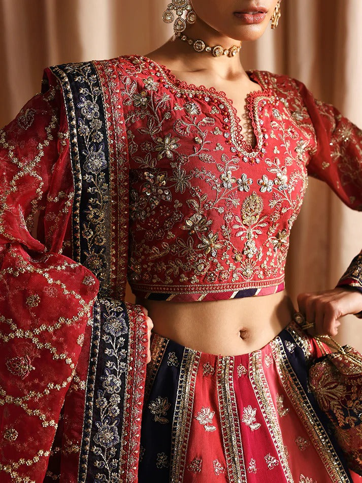 Red and blue embroidered traditional outfit with intricate patterns