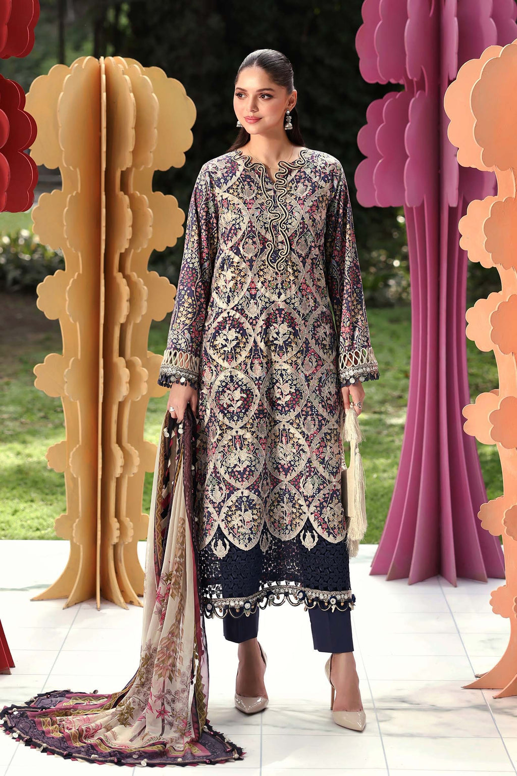 Woman in traditional outfit with decorative elements in a garden setting