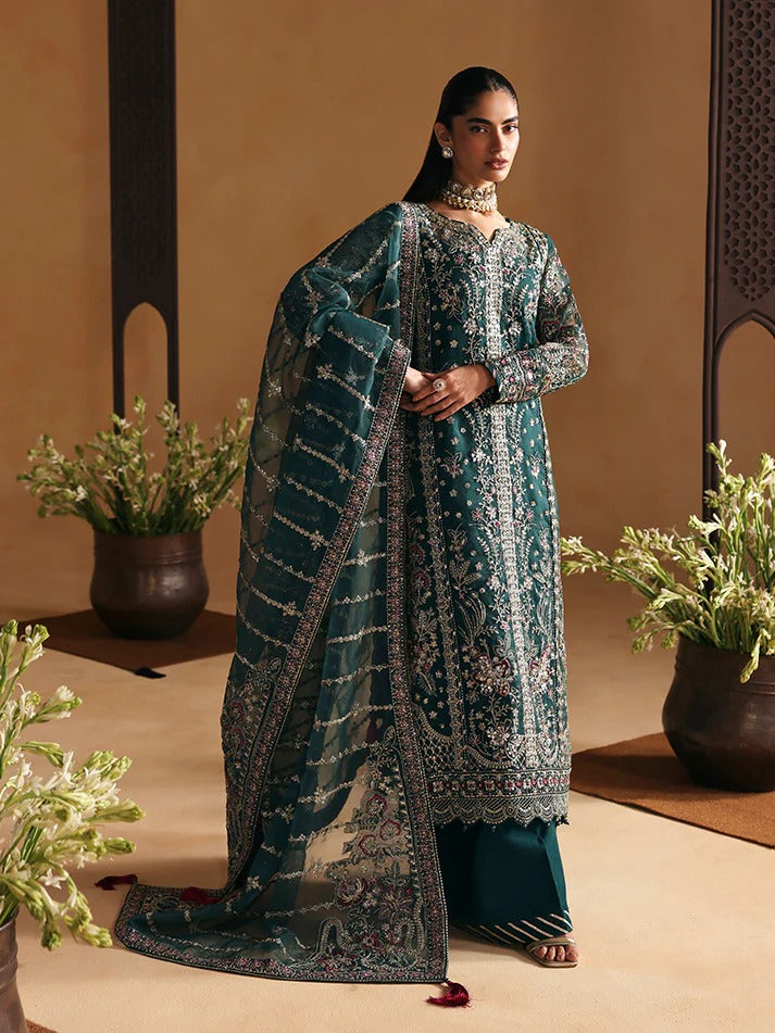 Woman in a traditional outfit with a patterned shawl against a beige background