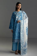 Woman wearing a blue floral dress with a matching dupatta on a gray background