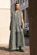 Woman in a traditional outfit standing on a street with a building in the background