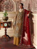 Woman in traditional embroidered outfit with red dupatta in an ornate room.