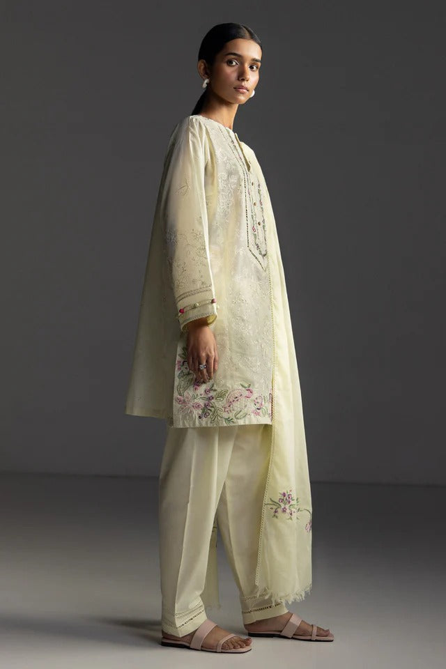 Woman wearing a traditional outfit with floral embroidery on a dark background