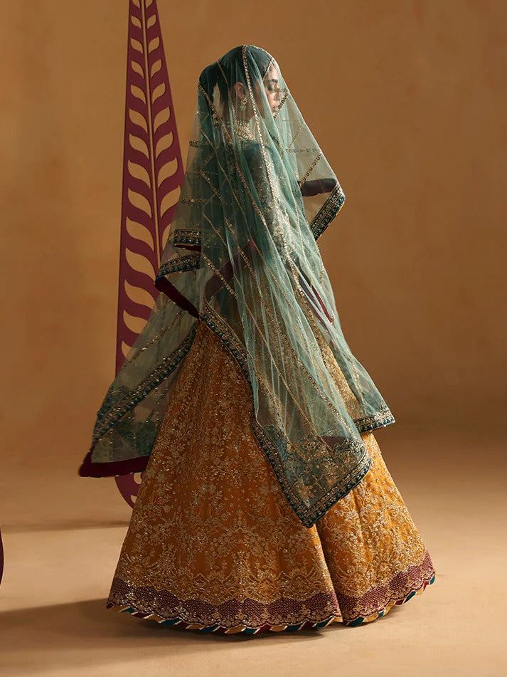 Traditional outfit with a green dupatta and orange skirt on a beige background