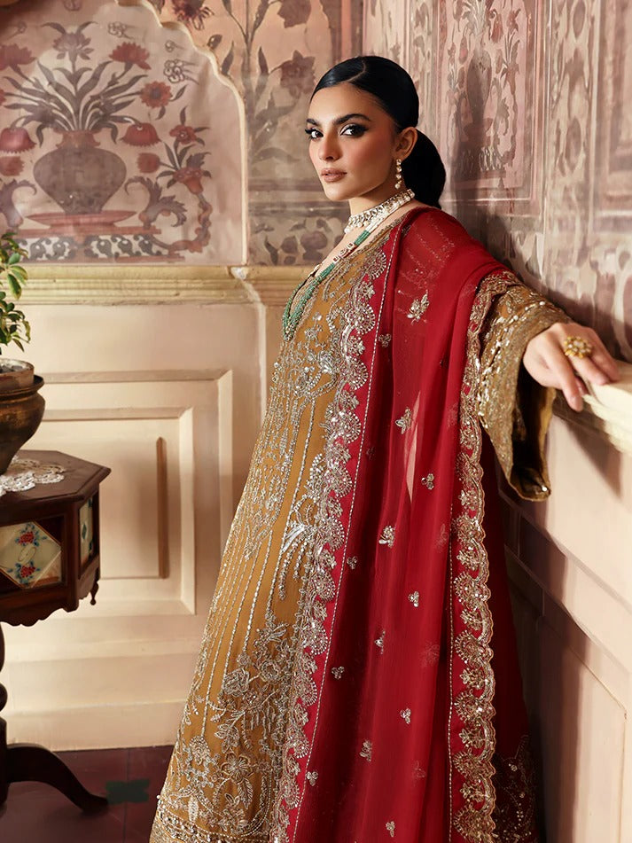 Woman in a red and gold traditional outfit standing in an ornate room.