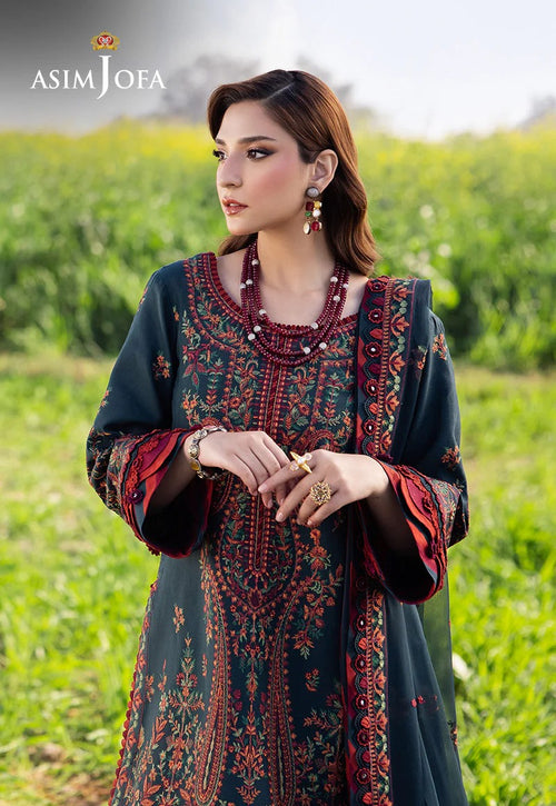 Woman wearing an embroidered dress with a green field background, featuring the Asim Jofa brand.